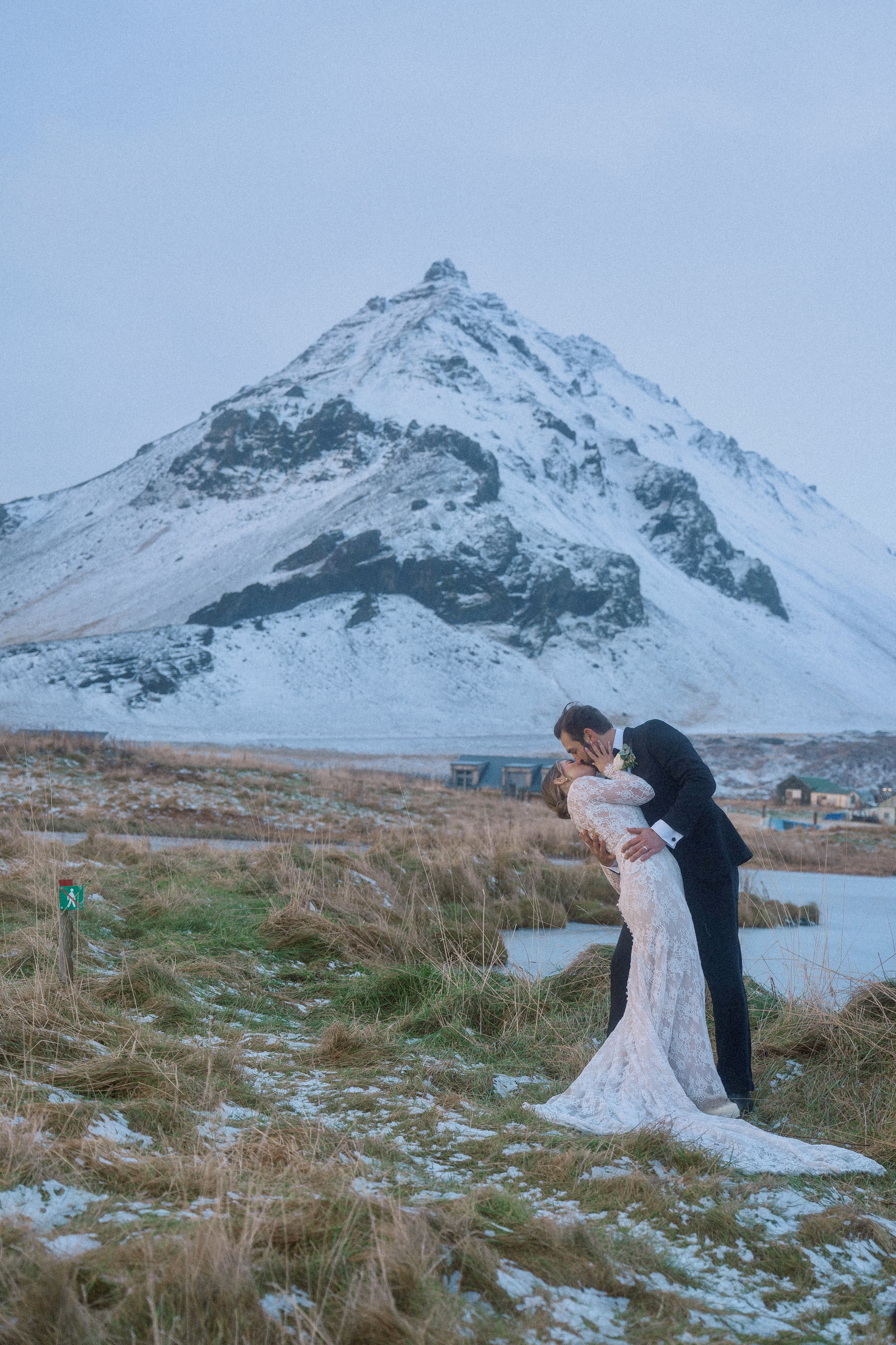 Wedding portrait beneath a snow-covered mountain