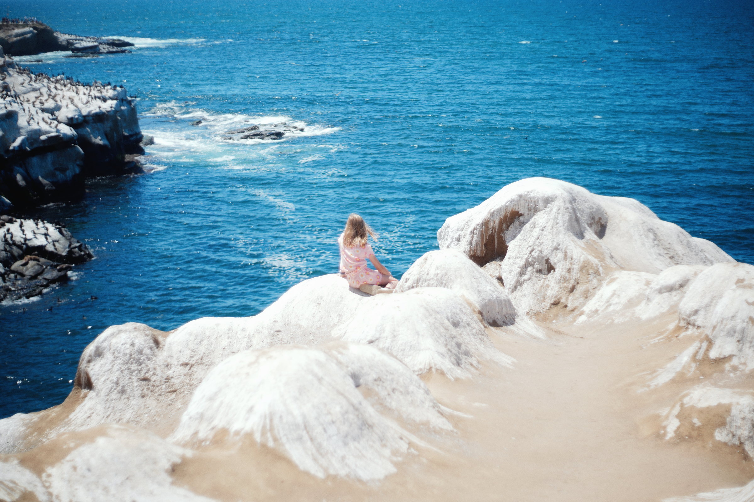 Rocky coastline beside blue water