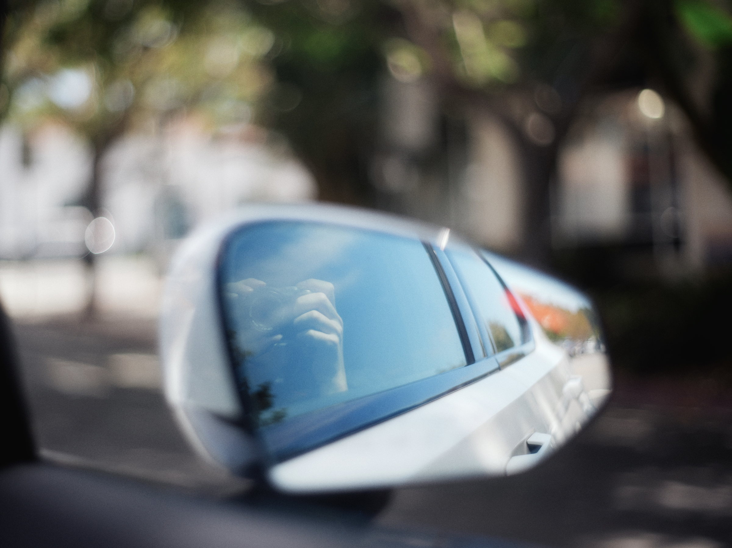 Car reflected in a side mirror